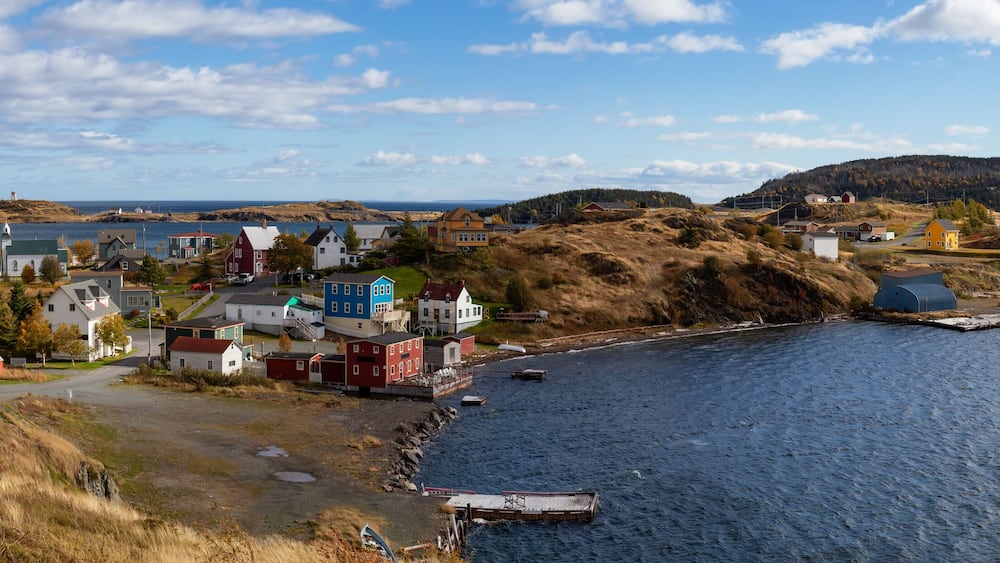 Aerial panoramic view of a small town on the Atlantic Ocean Coast during a sunny day. Taken in Trinity, Newfoundland and Labrador, Canada.