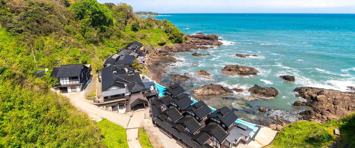 A coastal village with traditional houses by the sea.