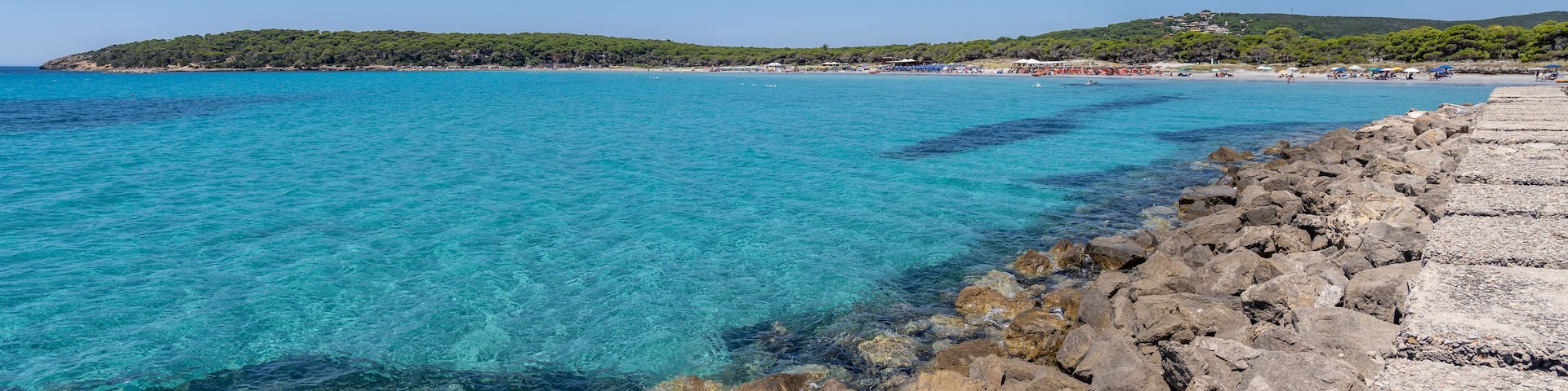 Porto Pino, Sardegna. Italy. The wonderful beach of Porto Pino with the sea in shades of turquoise blue. Tourist destination. Sea of Sardinia one of the most beautiful in Italy. Summer time