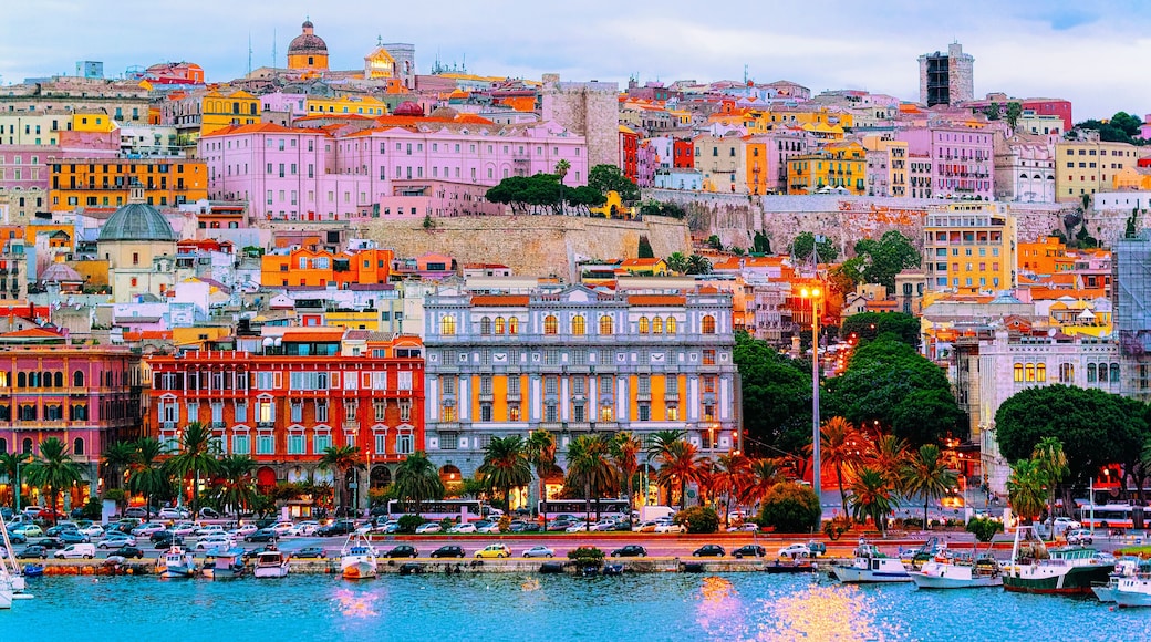 Old Sardinian Port with ships at Mediterranean Sea and city of Cagliari, South Sardinia Island in Italy in summer. Cityscape with marina and Yachts and boats in town