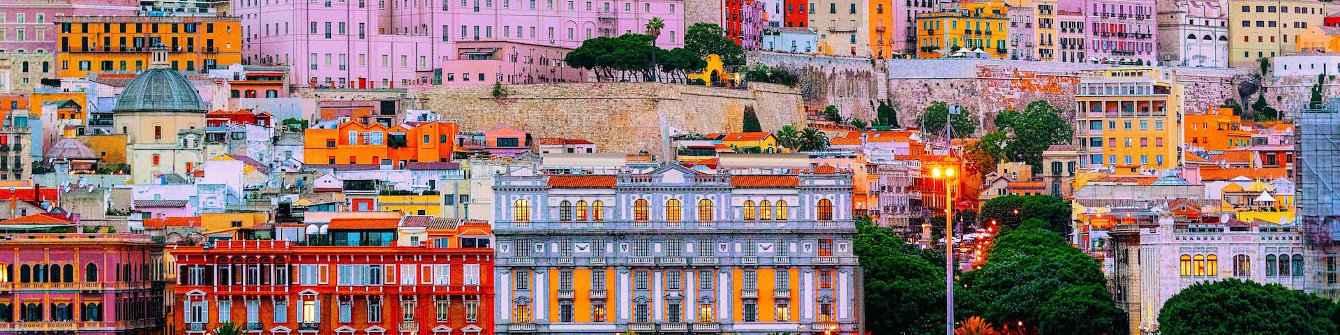 Old Sardinian Port with ships at Mediterranean Sea and city of Cagliari, South Sardinia Island in Italy in summer. Cityscape with marina and Yachts and boats in town