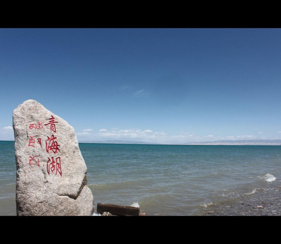 Double language milestone (Chinese and Tibetan). Qinghai Lake is easy to reach by bus from Xining