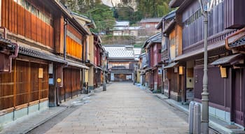 A traditional Japanese street with wooden buildings and a clear sky.