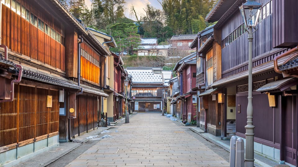 A traditional Japanese street with wooden buildings and a clear sky.