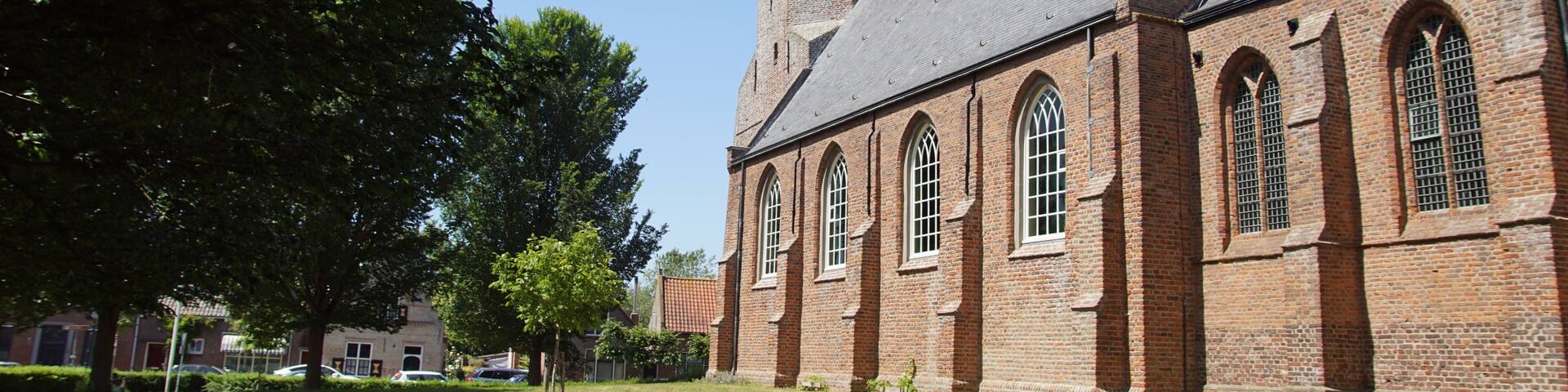 Dutch late Gothic church Corneliuskerk. A Protestant church in the Zeeland village of Noordwelle. Summer. Netherlands, June. Blue sky.
