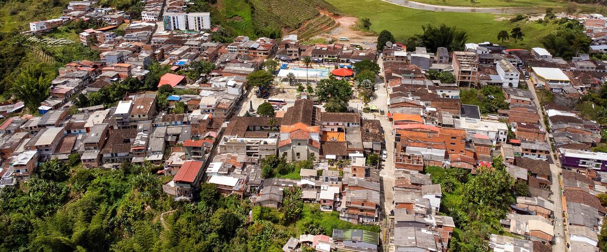 A densely packed hillside town with a river running through the valley.