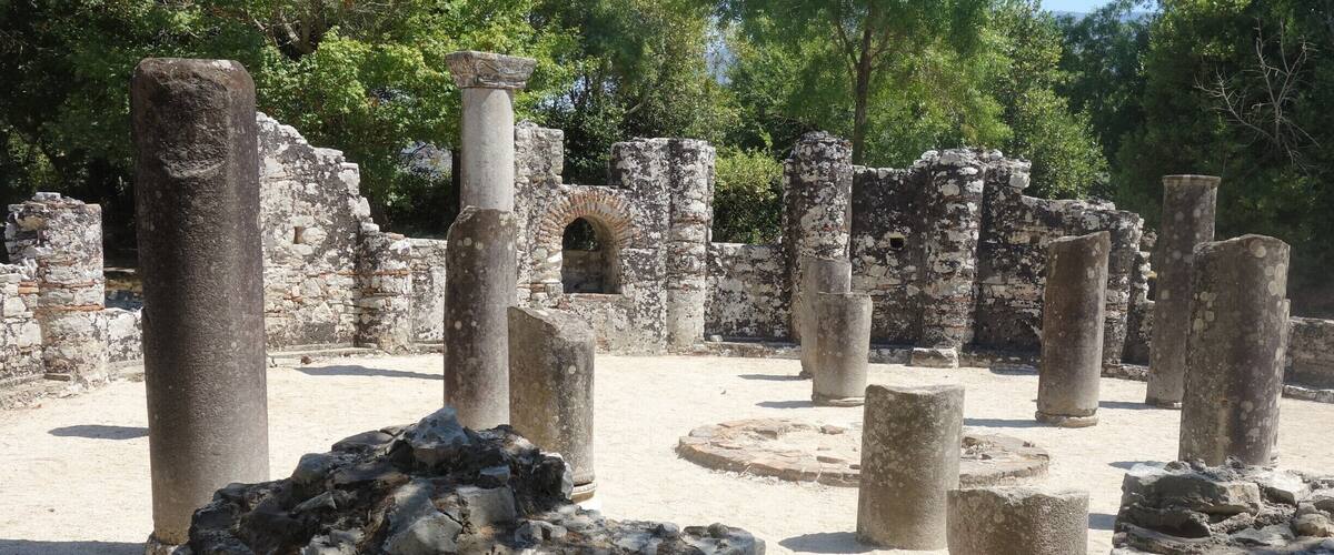 Ancient ruins with stone columns and arches.