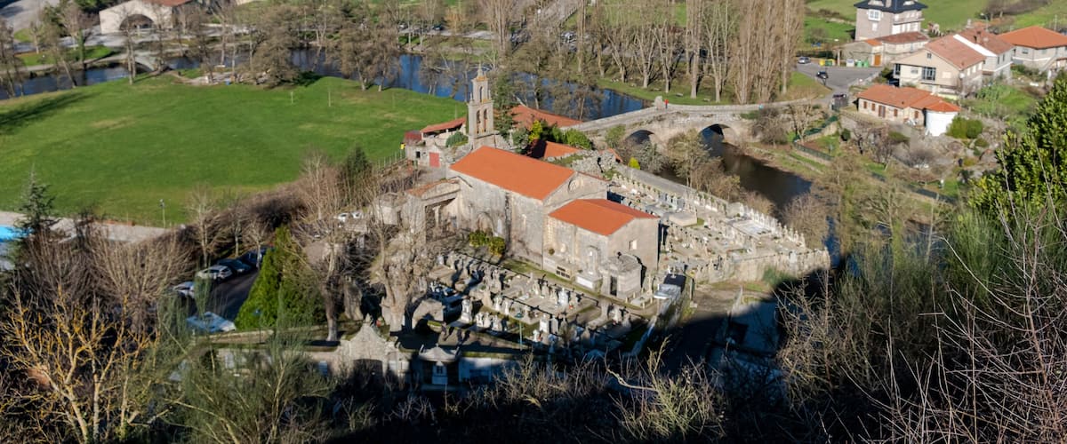 A historic town with a river, a bridge, and a prominent church.