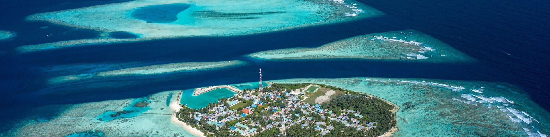 Aerial view of local, inhabited island Felidhoo, located in Vaavu Atoll, Maldives, Indian Ocean and the neigbor island Thinadhoo in the distance