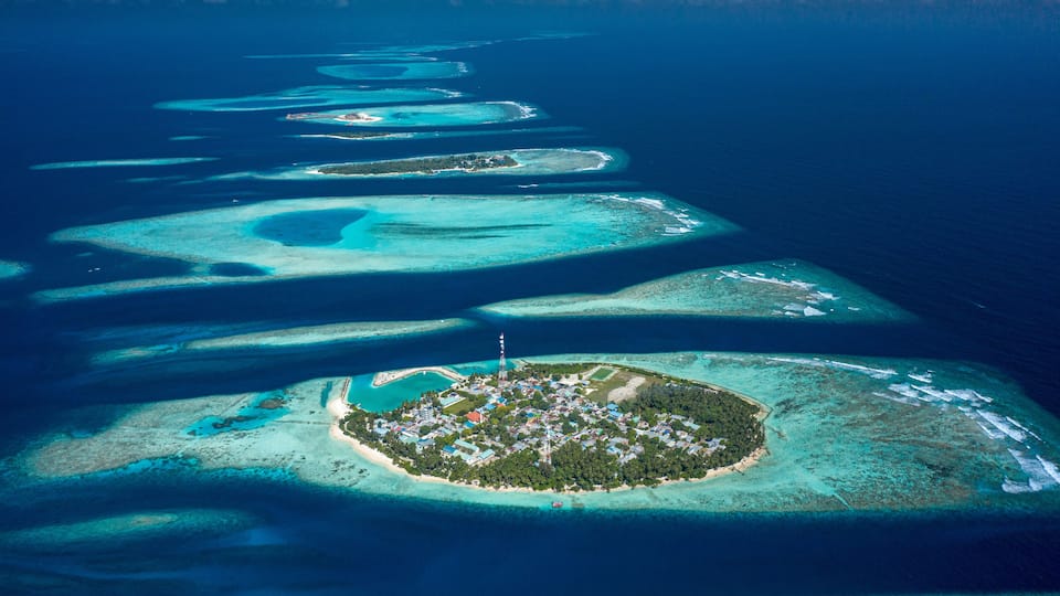 Aerial view of local, inhabited island Felidhoo, located in Vaavu Atoll, Maldives, Indian Ocean and the neigbor island Thinadhoo in the distance