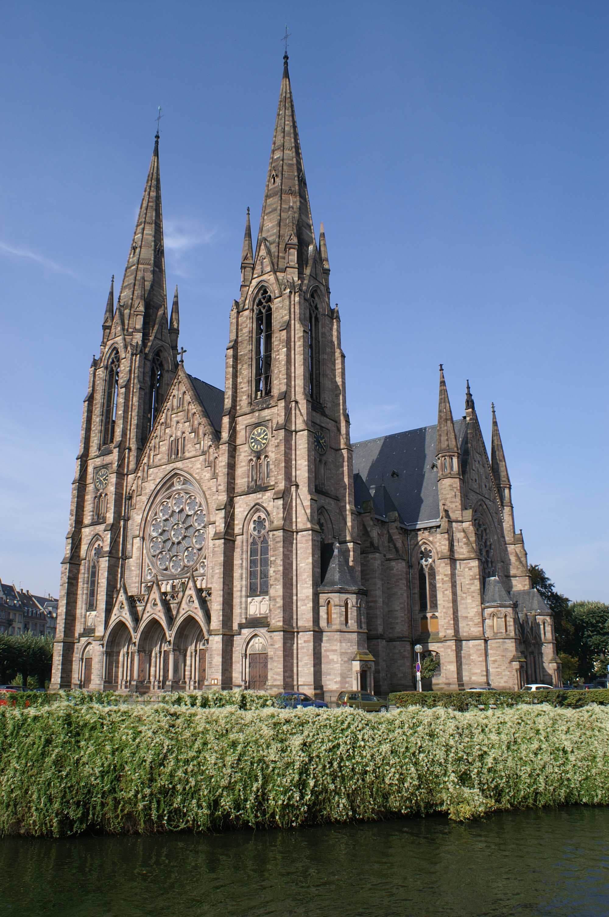 A large Gothic-style cathedral with multiple spires and a large central rose window.