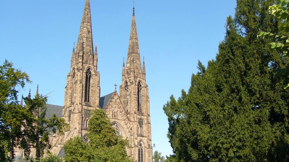 A historic church with two tall spires and intricate architecture.