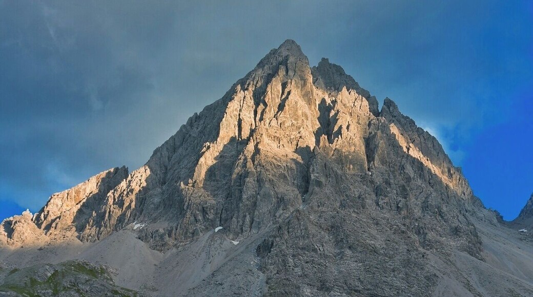 July 2015
Dremelspitze, Lechtaler Alps
Dremelspitze with 2.733 m summit is one of the peaks in Lechtaler Alps which can be ascended without climbing or special gear (of course it is not an easy walk either). It is located between the Hanauer Huette and Steinsee-Huette with saddle of some 2.500 meters both on west and east side of this beauty.
It is made of limestone Dolomite as the whole Lechtaler Alps so it is white greyish during the day, but in the golden hour it gets a cosy warm Colour thanks to the descending sun.