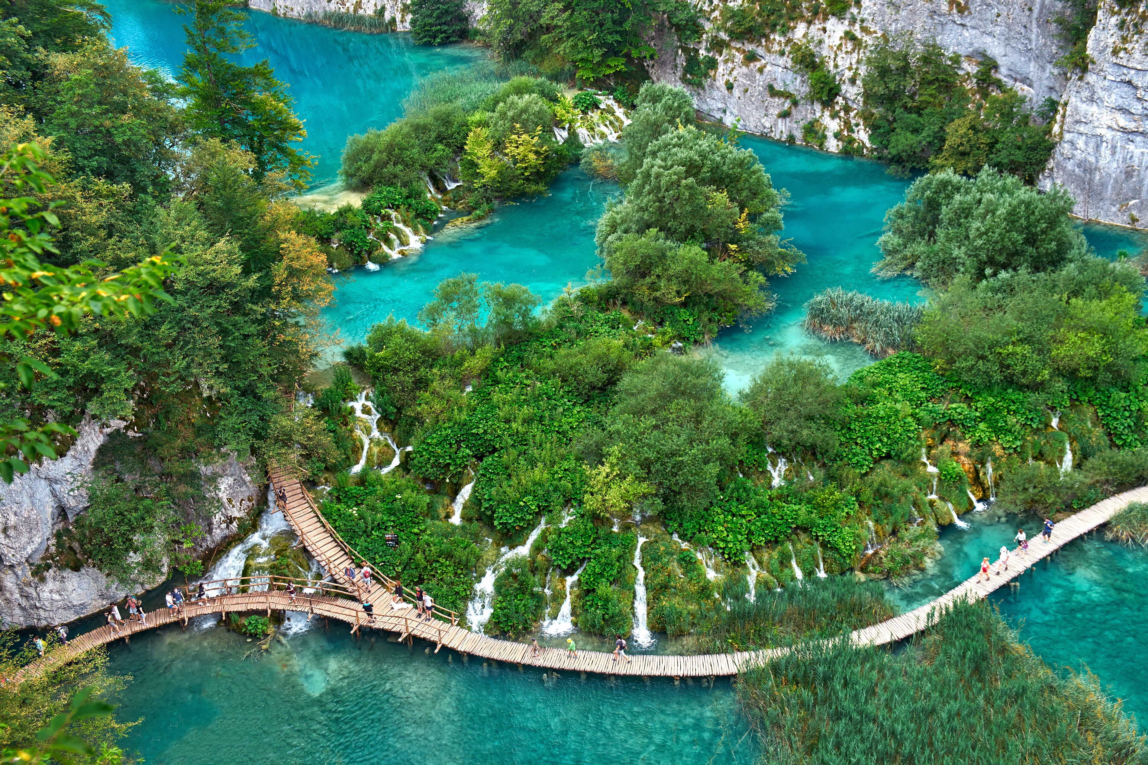 PLITVICE, CROATIA - JULY 29: Tourist enjoy sightseeing the lakes and wonderful landscapes at the Plitvice natural Park in Croatia during the summer holidays, on July 29th, 2016 in Plitvice, Croatia