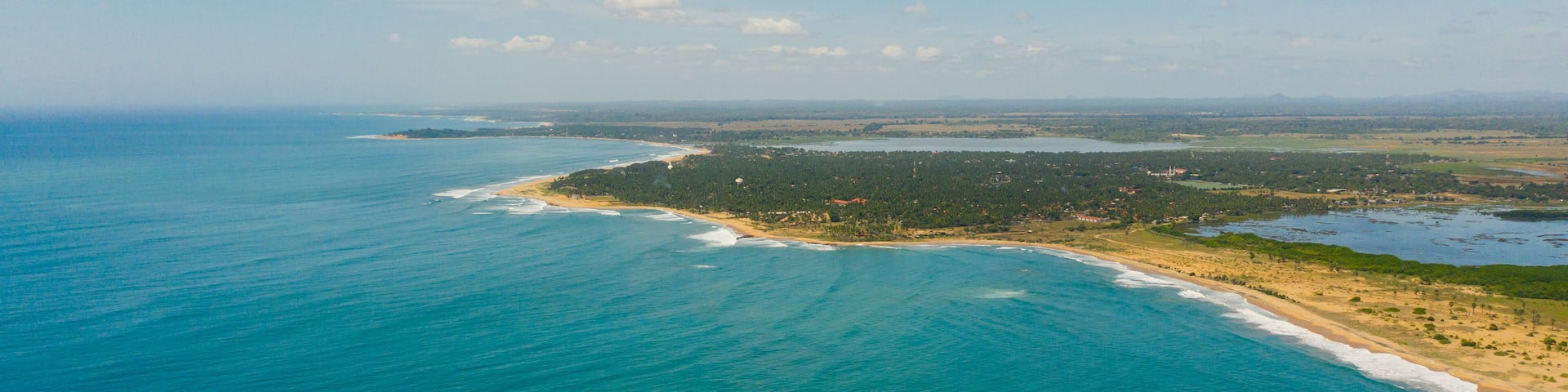 Tropical landscape of the island of Sri Lanka with beaches, ocean and agricultural land.