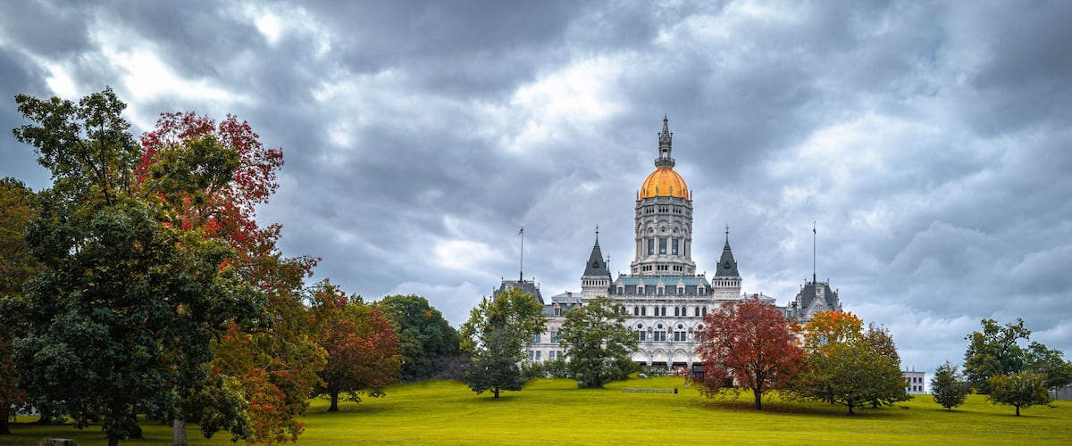 Dramatic cloudscape and autumn landscape over Connecticut State Capital building in Bushnell Park in Hartford, Connecticut