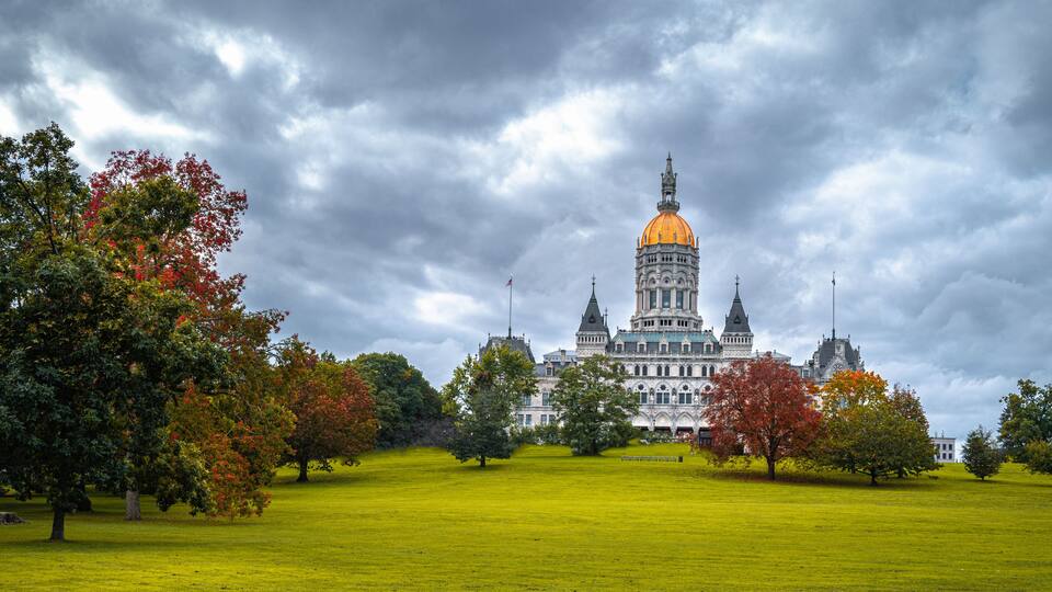 Dramatic cloudscape and autumn landscape over Connecticut State Capital building in Bushnell Park in Hartford, Connecticut