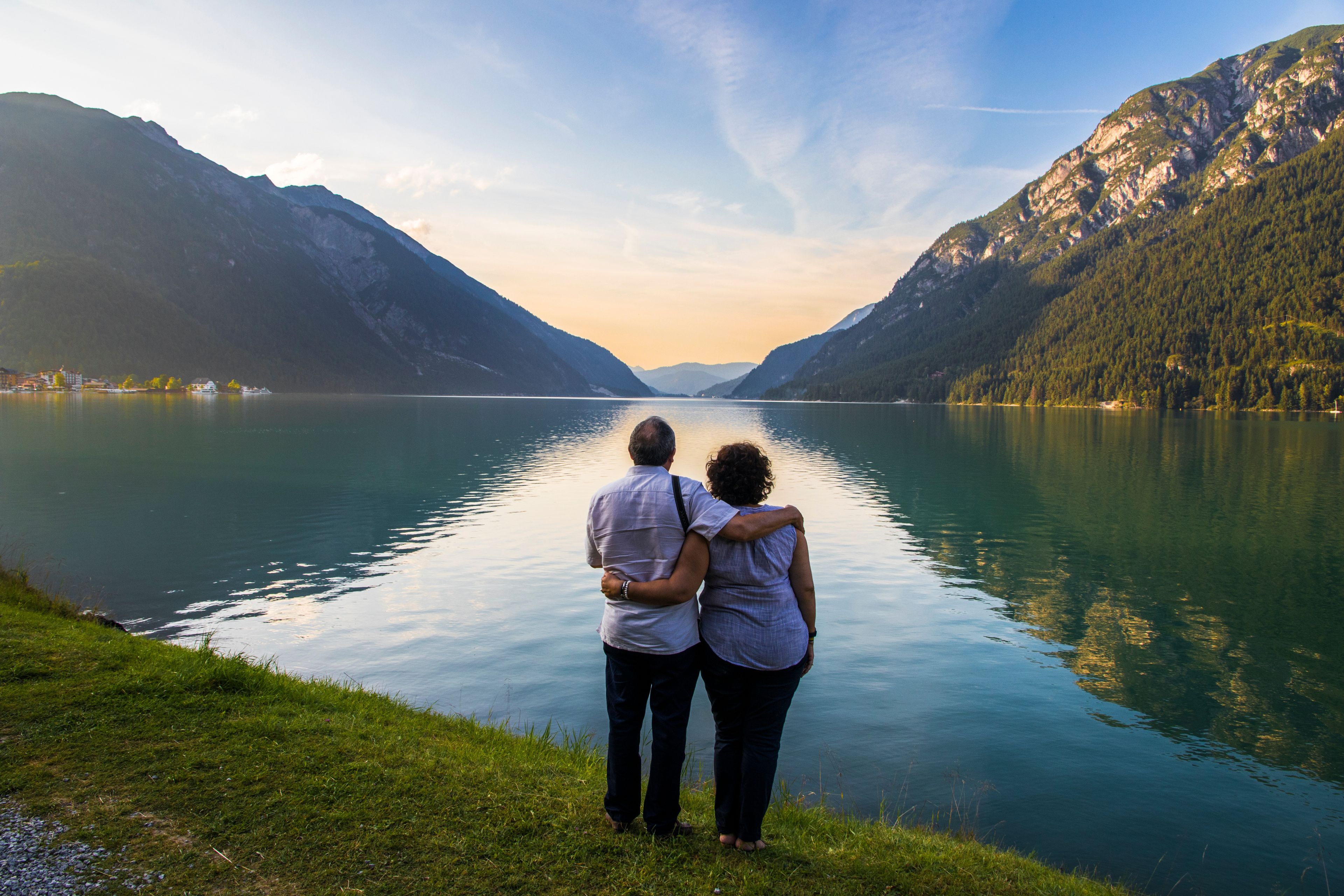 Senior couple watching sunset at Lake Achen (Achensee), a lake north of Jenbach in Tyrol, Austria