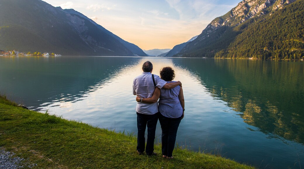 Senior couple watching sunset at Lake Achen (Achensee), a lake north of Jenbach in Tyrol, Austria