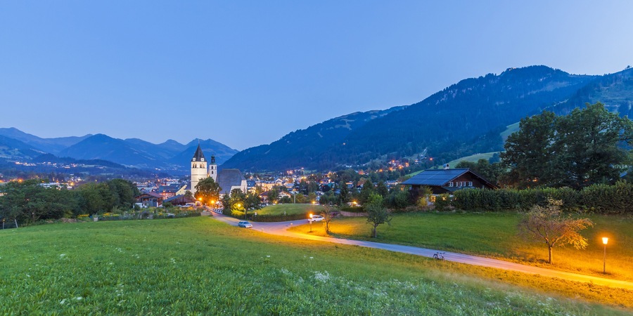 Austria, Tyrol, Kitzbuehel, townscape with churches at dusk; Shutterstock ID 395699605