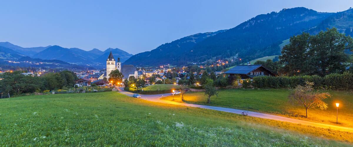 Austria, Tyrol, Kitzbuehel, townscape with churches at dusk; Shutterstock ID 395699605