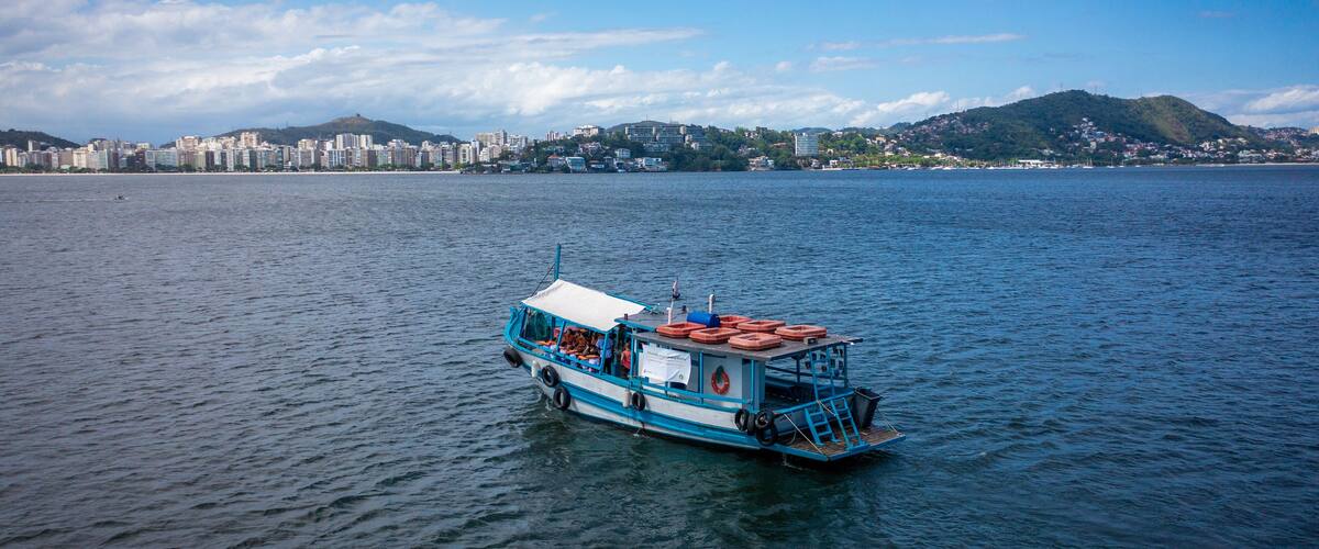 Beautiful aerial view of Guanabara Bay with a tourist boat sailing in the city of Niterói, Rio de Janeiro, Brazil