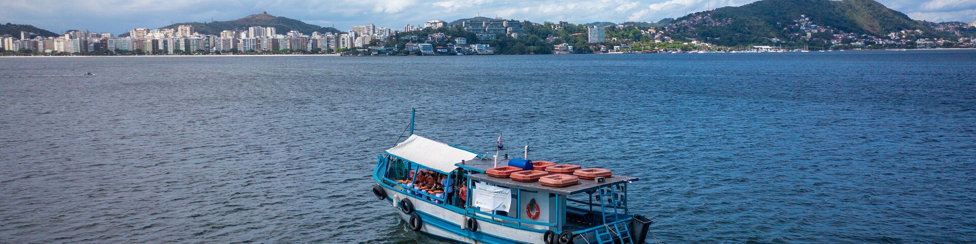 Beautiful aerial view of Guanabara Bay with a tourist boat sailing in the city of Niterói, Rio de Janeiro, Brazil