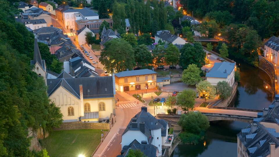 An aerial view of a historic town with a river, bridges, and traditional architecture.