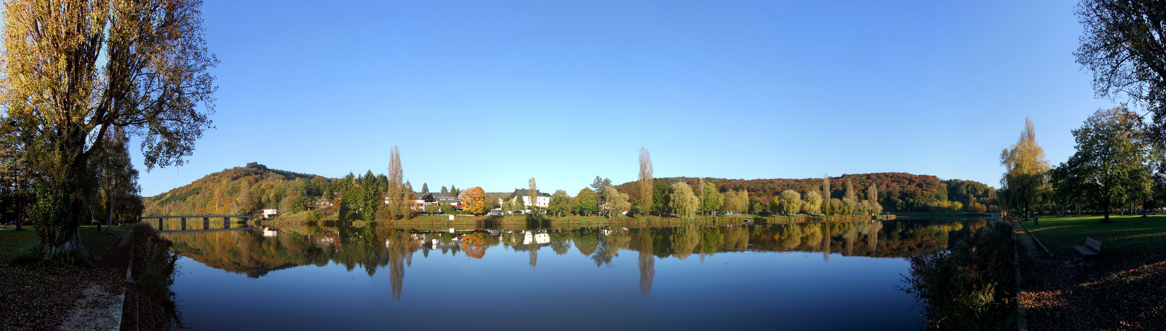 Panoramic view of the Sauer border river between the villages of Rosport / Luxembourg and Ralingen / Germany in autumn