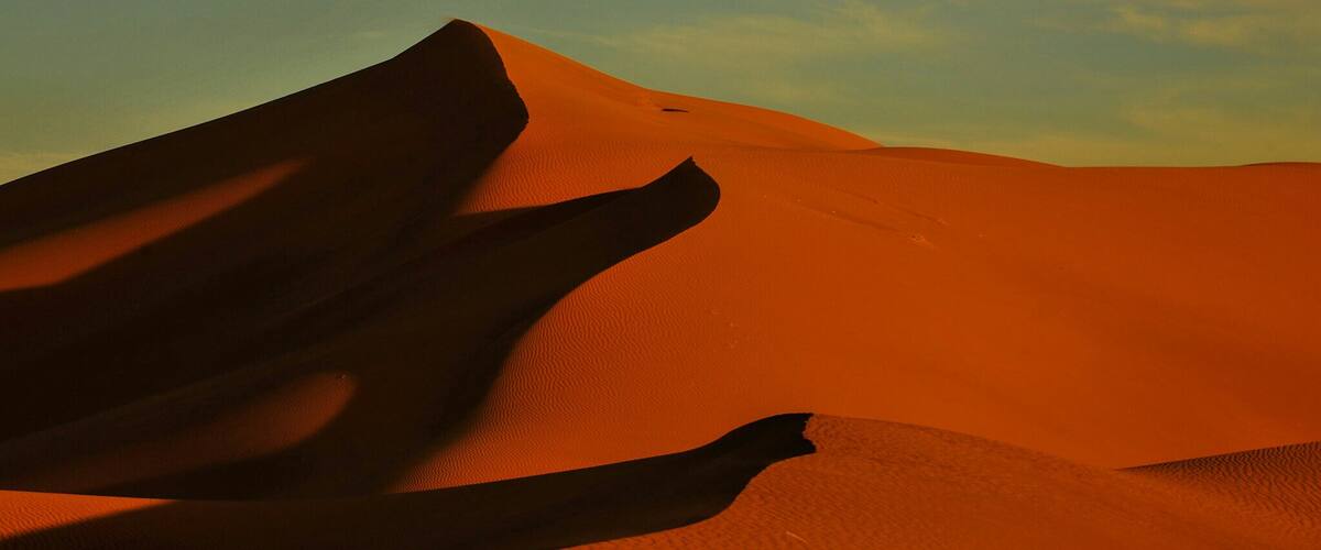 A sand dune with shadows.