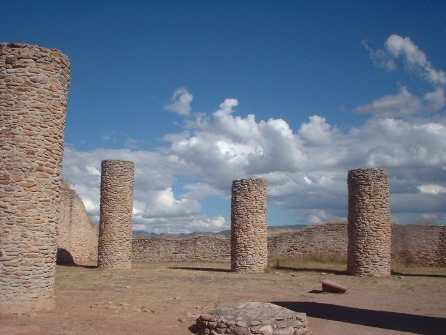 Ancient stone pillars in a desert landscape.