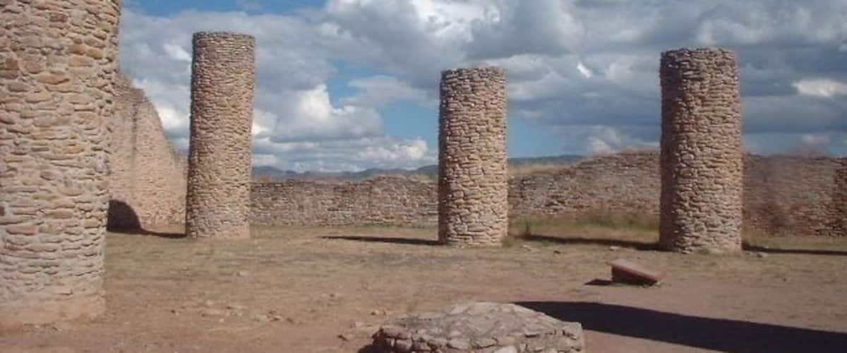 Ancient stone pillars in a desert landscape.