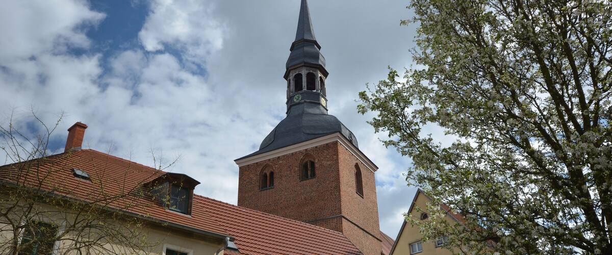 A church with a tall steeple and a clock tower.