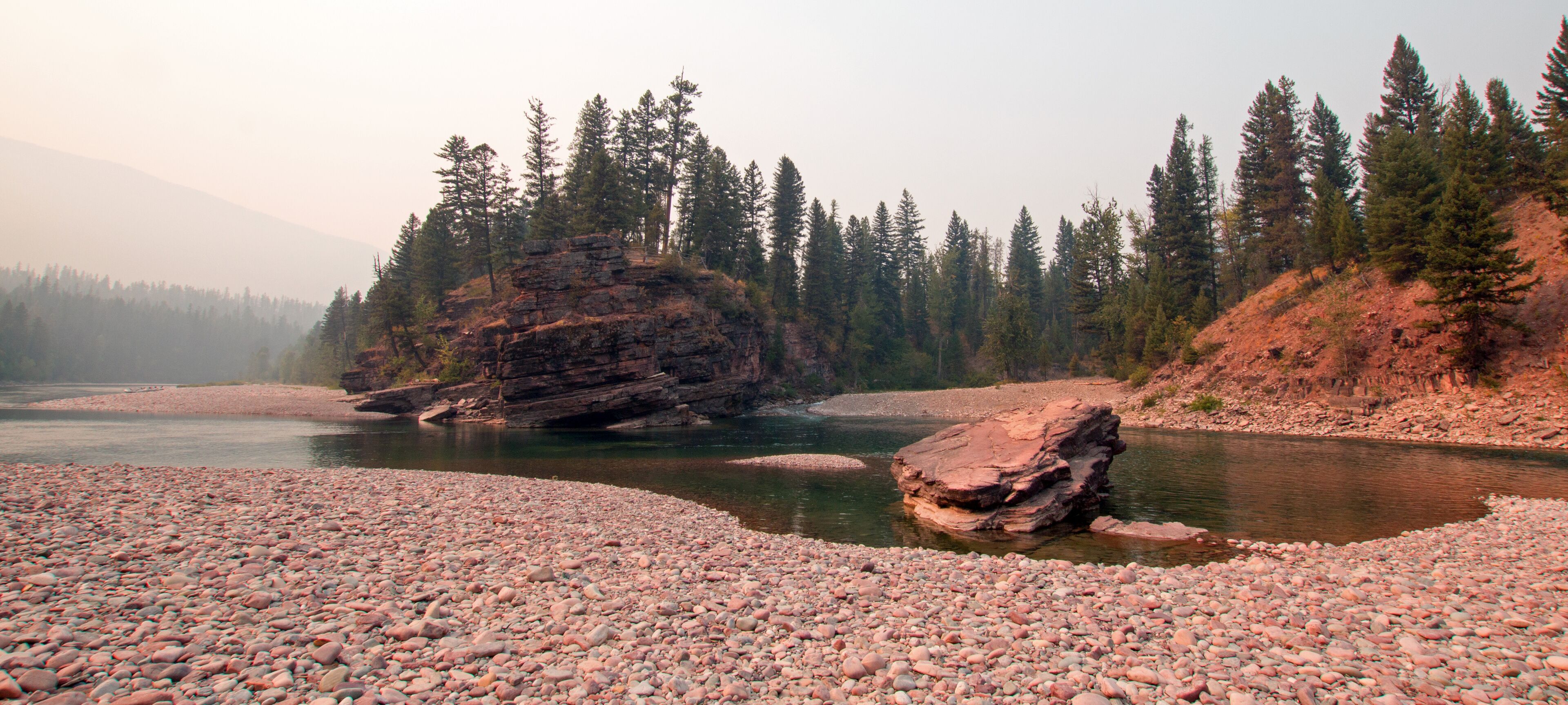 Gravel river banks where the Flathead and Spotted Bear Rivers meet in the Bob Marshall wilderness area during the 2017 fall fires in Montana United States