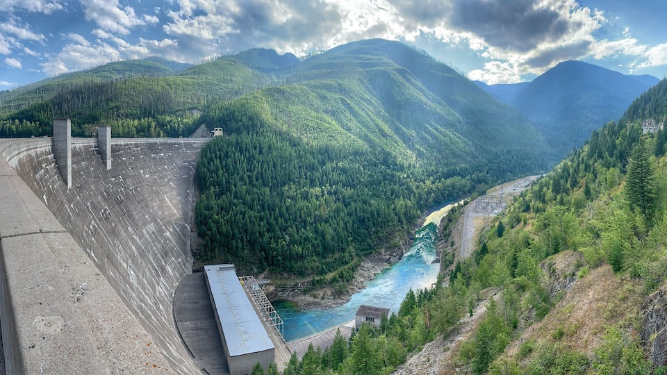 A dam, a river, and a mountainous landscape.