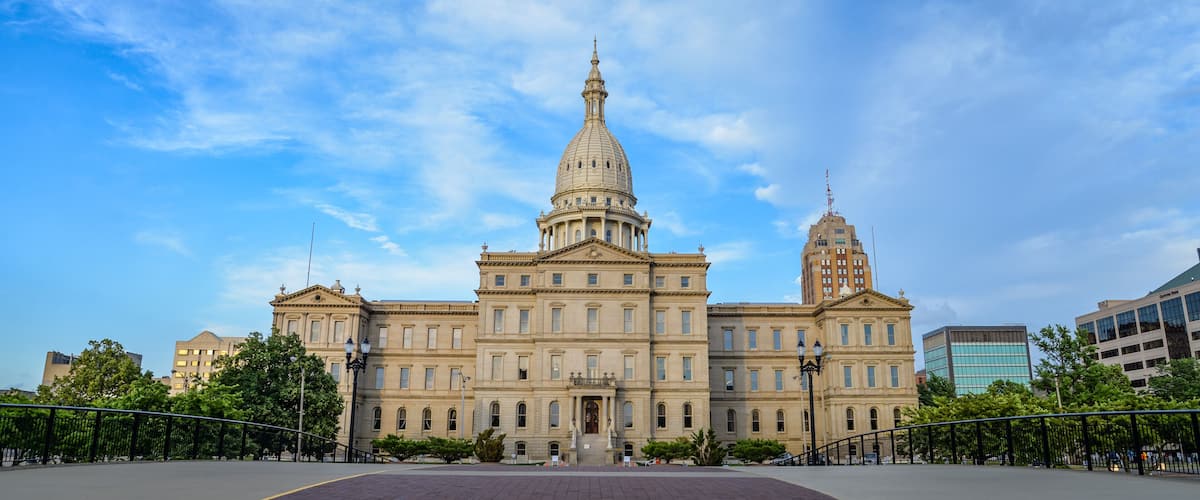 A large, historic building with a prominent dome and a tall tower.