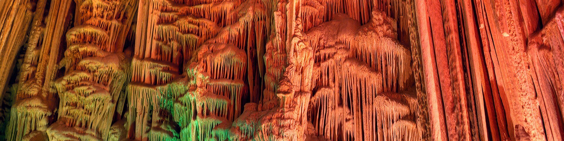 Una cueva con estalactitas y estalagmitas de colores.