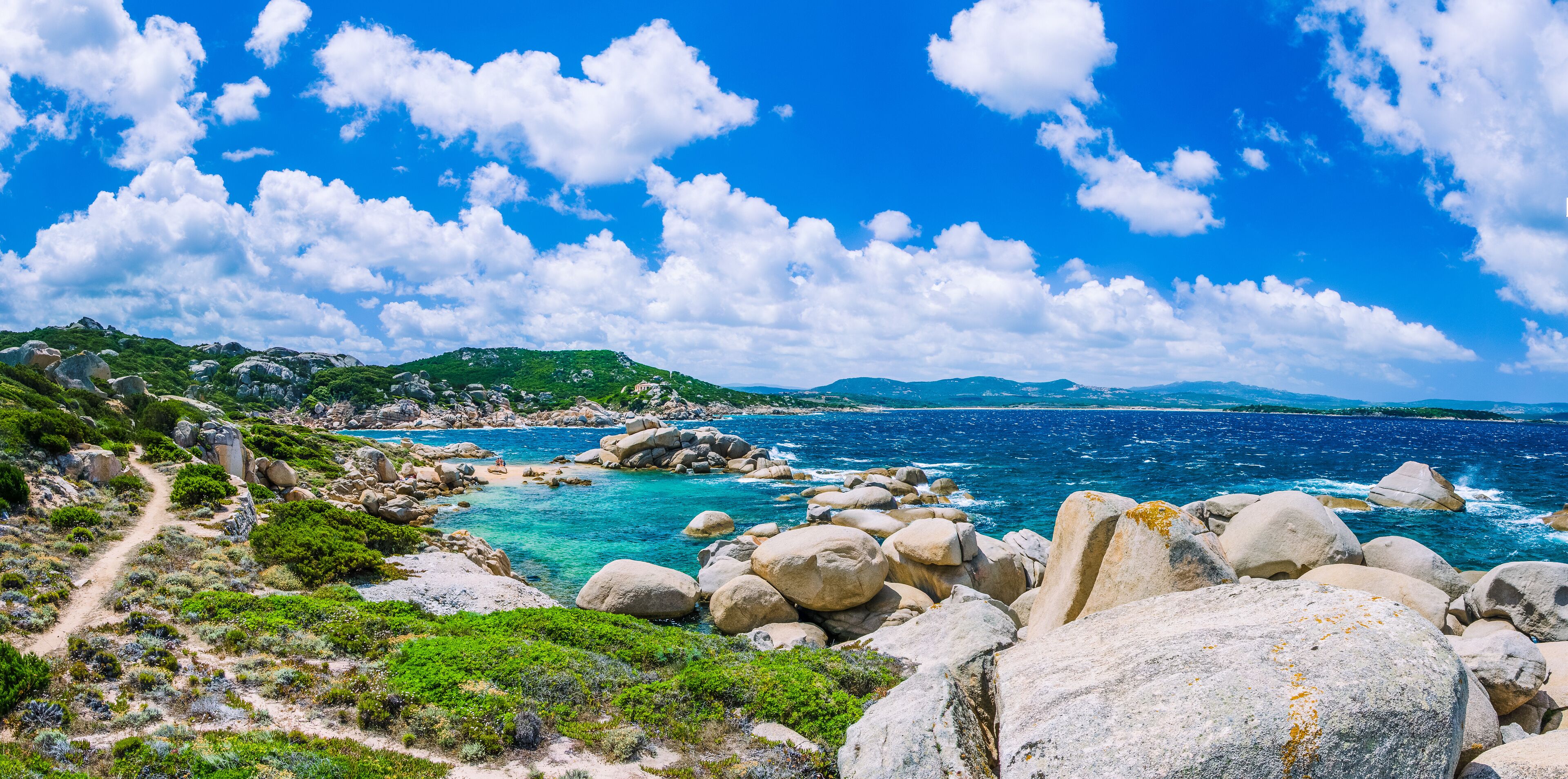 Walking path along sandstone rocksy coastline of Costa Serena, Sardinia, Italy