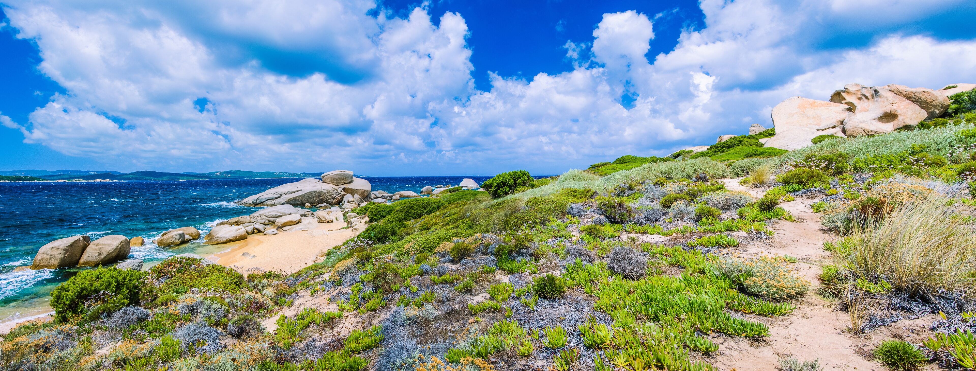 Walking path along sandstone rocksy coastline of Costa Serena, Sardinia, Italy