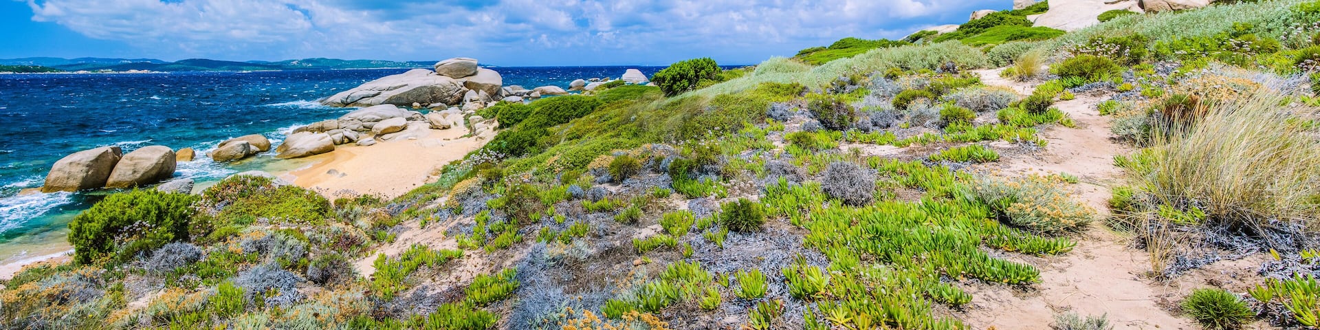 Walking path along sandstone rocksy coastline of Costa Serena, Sardinia, Italy