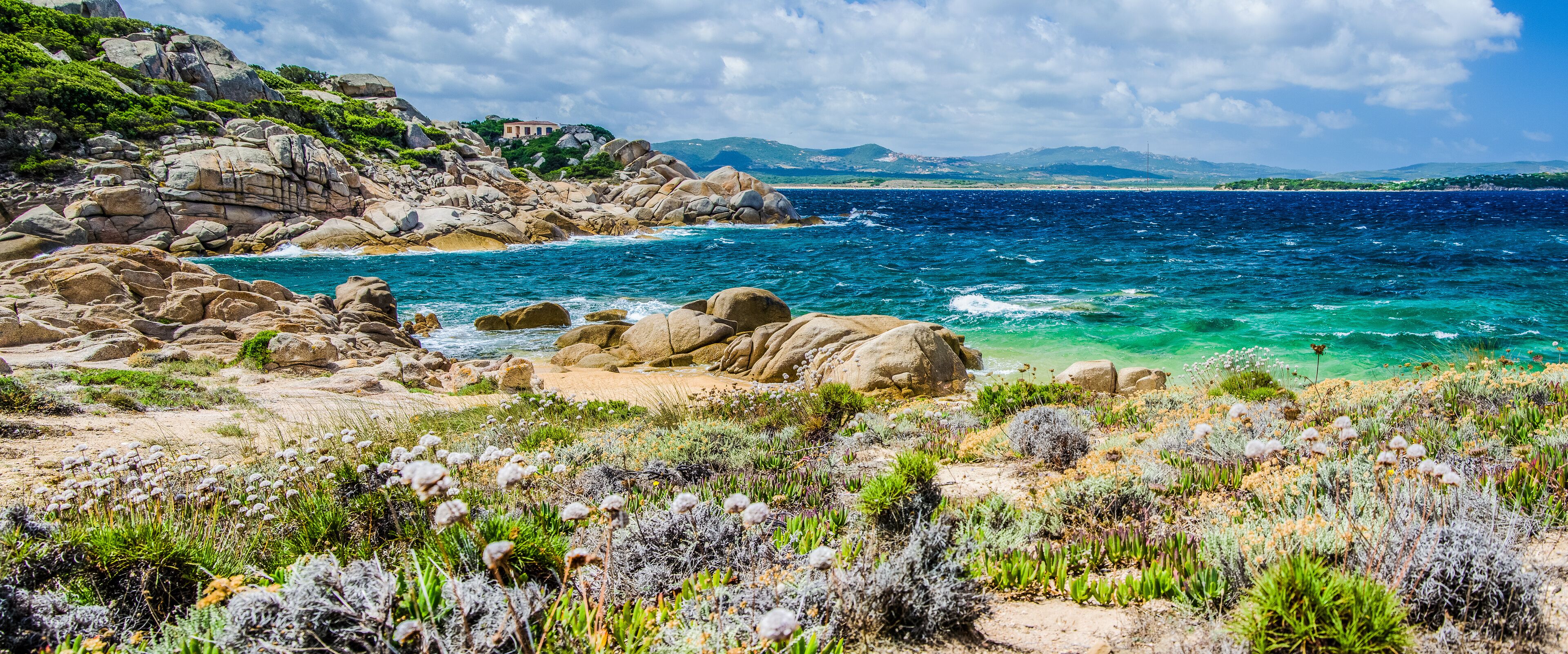 Costline of Costa Serena with sandstone rocks and sea waves, Sardinia, Italy