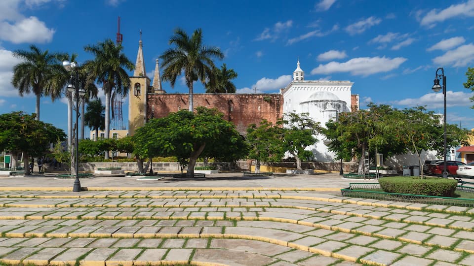 Santa Ana park and church with tropical trees, Merida, Yucatan, Mexico