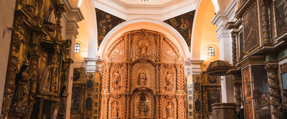 An ornate church interior with detailed carvings and statues.