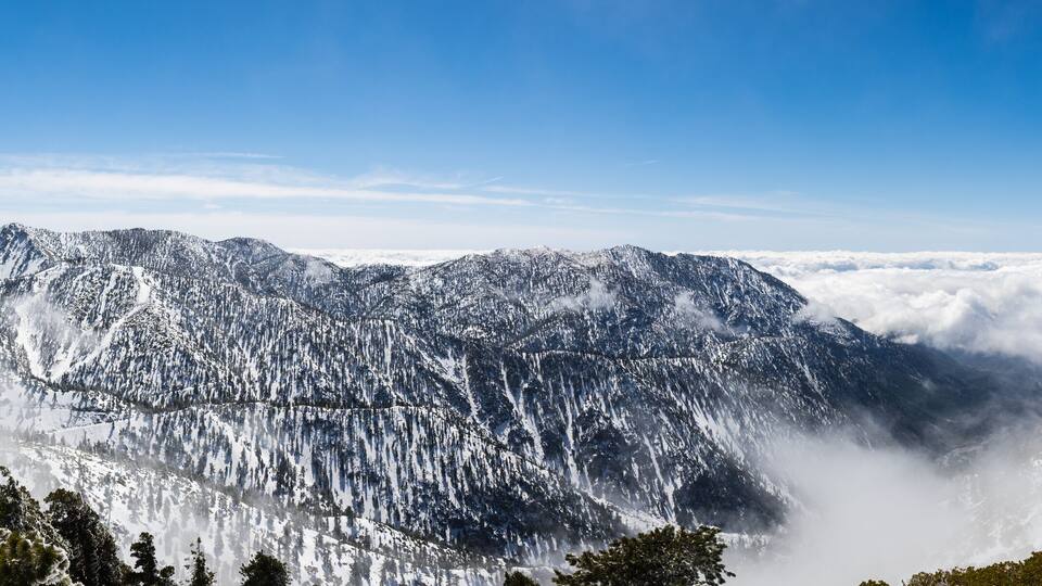 A snow-covered mountain range with a clear sky.