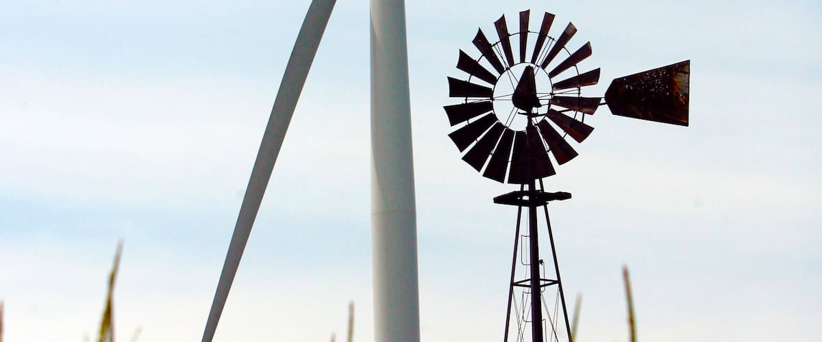 A windmill in a field of crops.