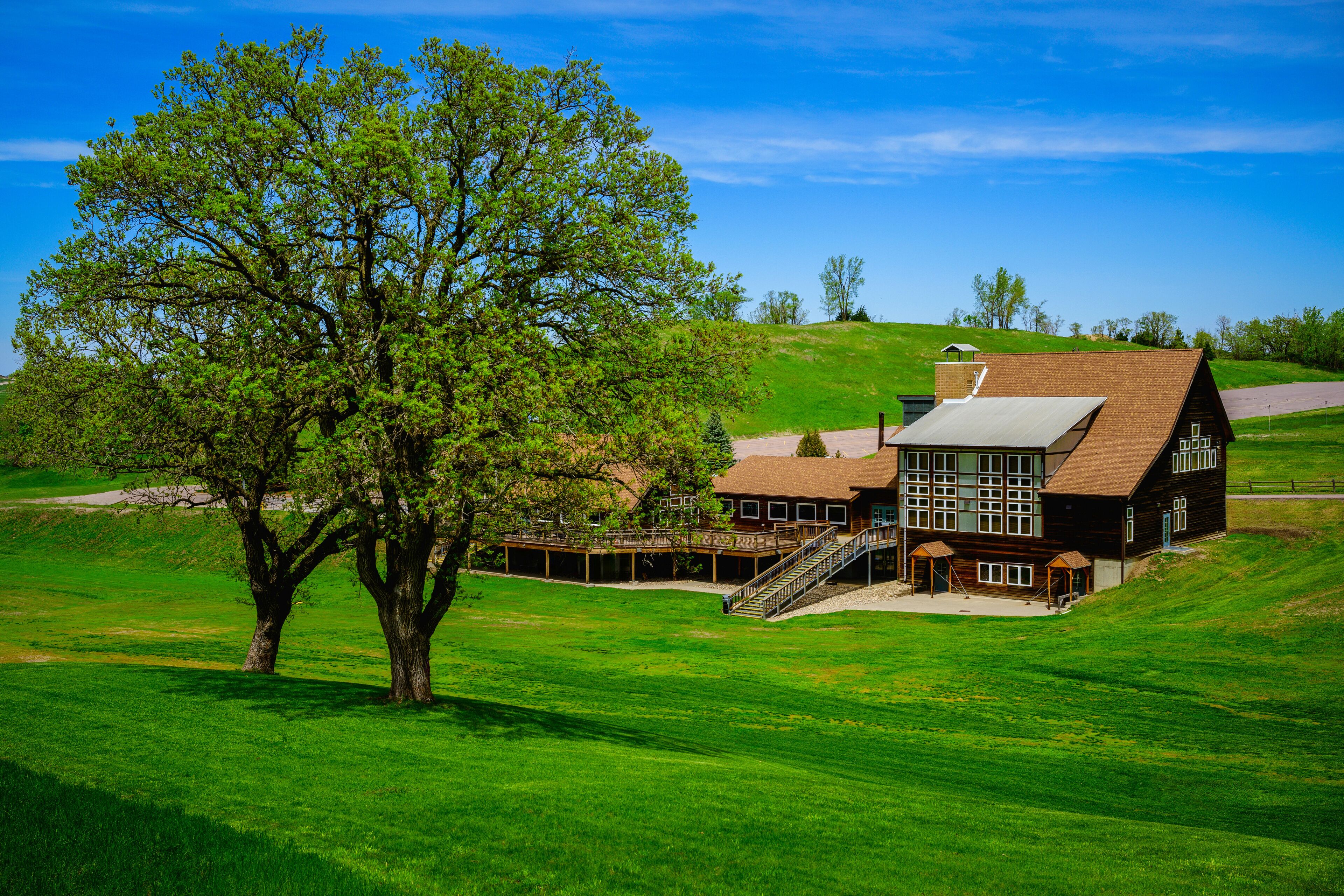 Tranquil Vibrant Springtime Landscape with tall oak trees and houses nestled at Great Bear Ski Valley in South Dakota, USA