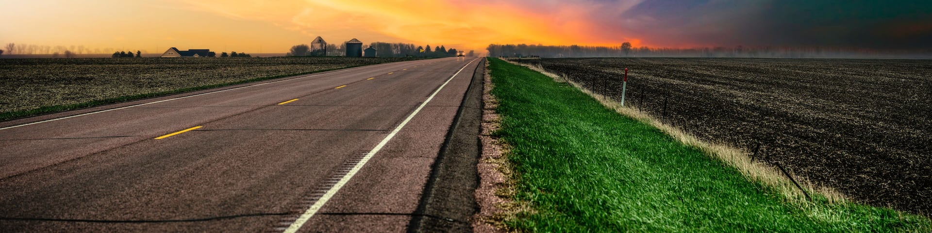 South Dakota Stormy Sunset on the rural road and the agricultural field in Lincoln County, a beautiful landscape of the American Heartland of the Upper Midwest, USA