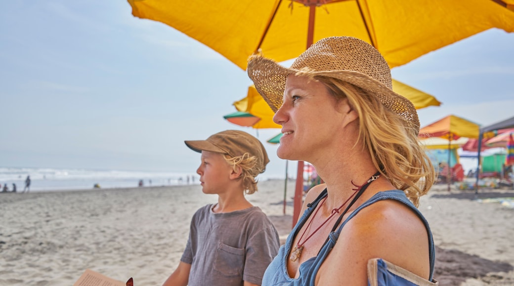 Mature woman and son relaxing on beach, Camana, Arequipa, Peru
