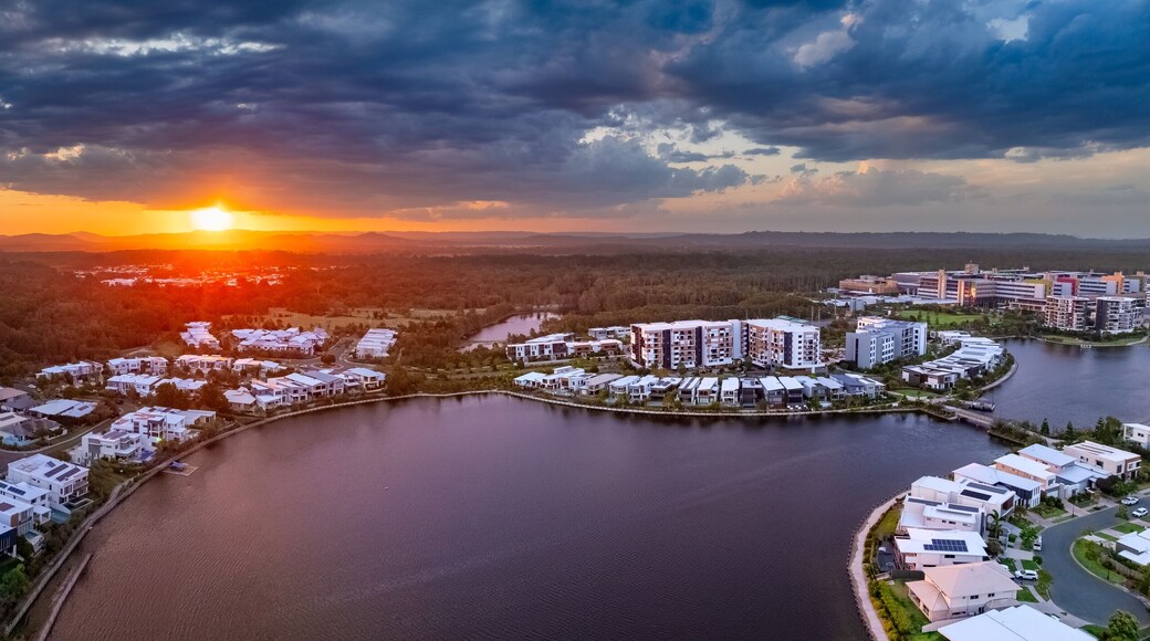 Aerial panorama of the Sun breaking through over waterfront property along inland canals