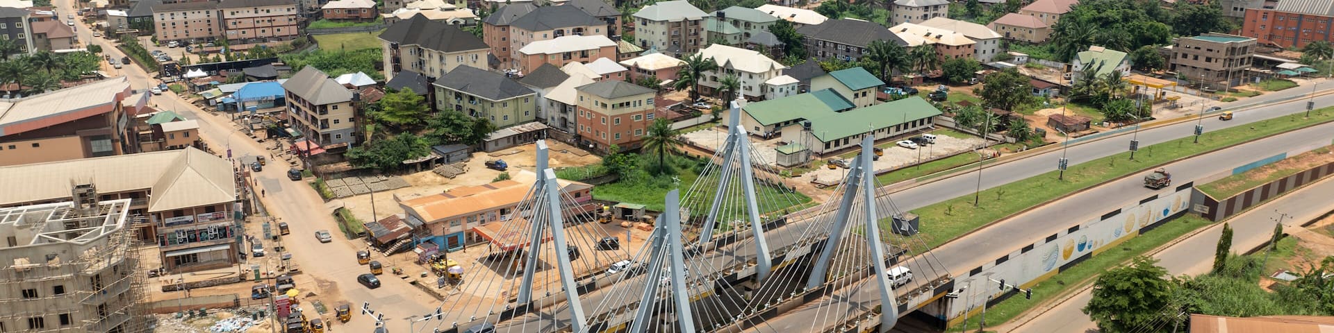 Aerial view of amawbia bridge spanning over bustling traffic and urban landscape, awka south, nigeria.